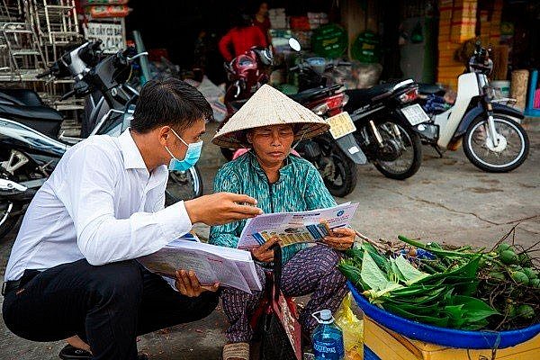 Tuyên truyền chính sách bảo hiểm xã hội tới tiểu thương tại chợ Tam Kỳ (Quảng Nam). Ảnh: BHXHVN