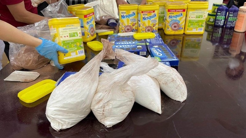 20 túi tinh thể màu trắng được ngụy trang tinh vi dưới đáy của các hộp cacao, sau đó phủ bằng một lớp bột cacao lên trên các túi và đóng gói tinh vi, trà trộn lẫn với bánh kẹo và các mặt hàng tiêu dùng khác hòng qua mặt lực lượng chức năng.