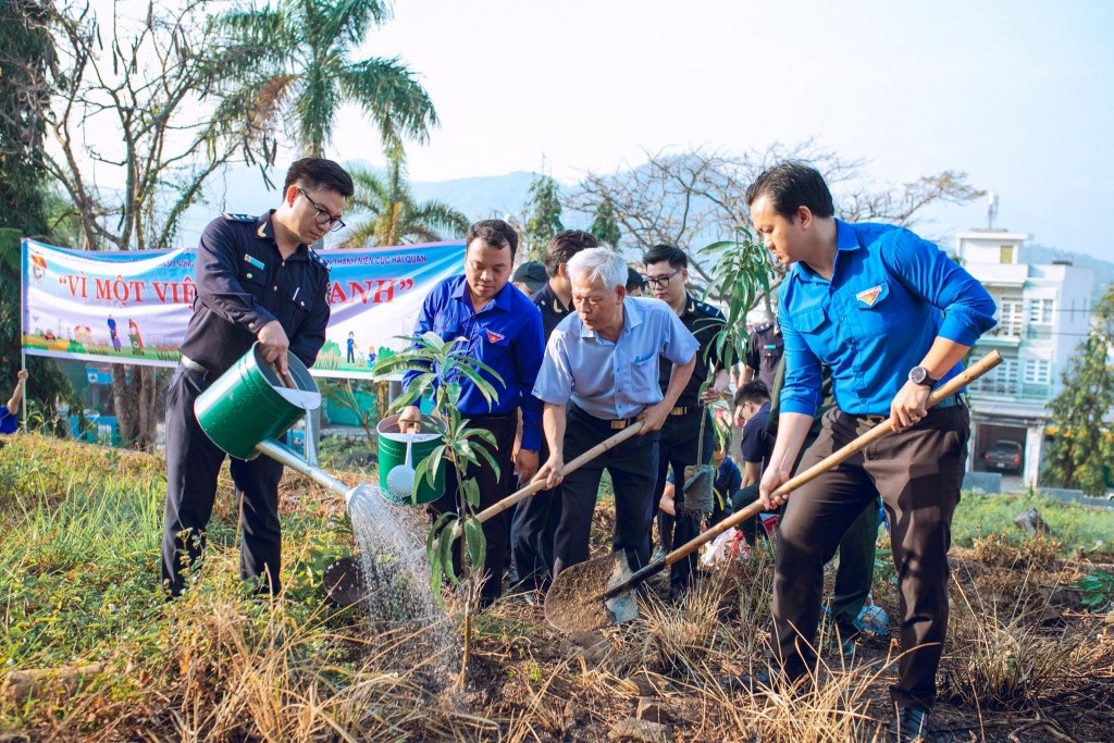 Các đại biểu cùng các đoàn viên thanh niên tham gia trồng cây trong khuôn viên Nghĩa trang liệt sỹ Hòn Dung.