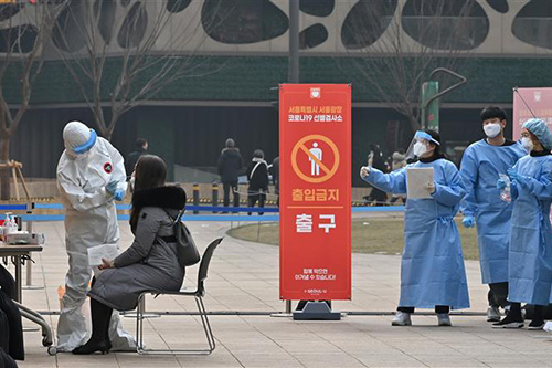 Nhân viên y tế lấy mẫu dịch xét nghiệm COVID-19 cho người dân tại Seoul, Hàn Quốc