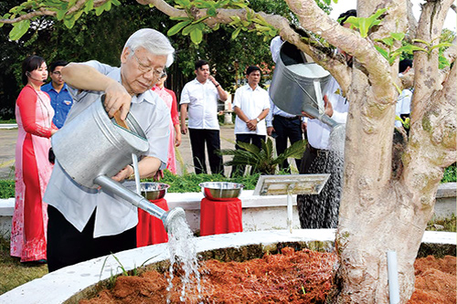 Tổng Bí thư Nguyễn Phú Trọng chăm sóc cây mai vàng tại khu tưởng niệm Cụ Phó bảng