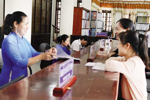 C&aacute;n bộ KBNN Bạc Li&ecirc;u hỗ trợ người d&acirc;n l&agrave;m thủ tục thanh to&aacute;n. Ảnh: T.T