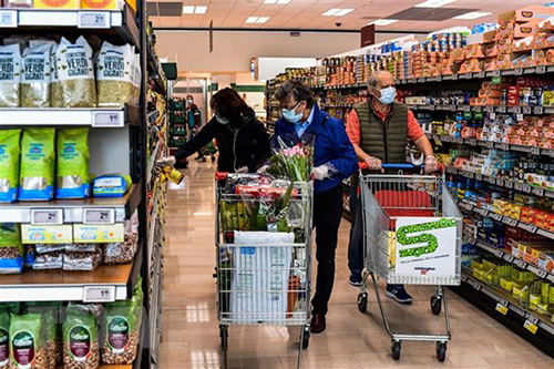 Người dân mua hàng hóa trong siêu thị tại Milan, Italy.